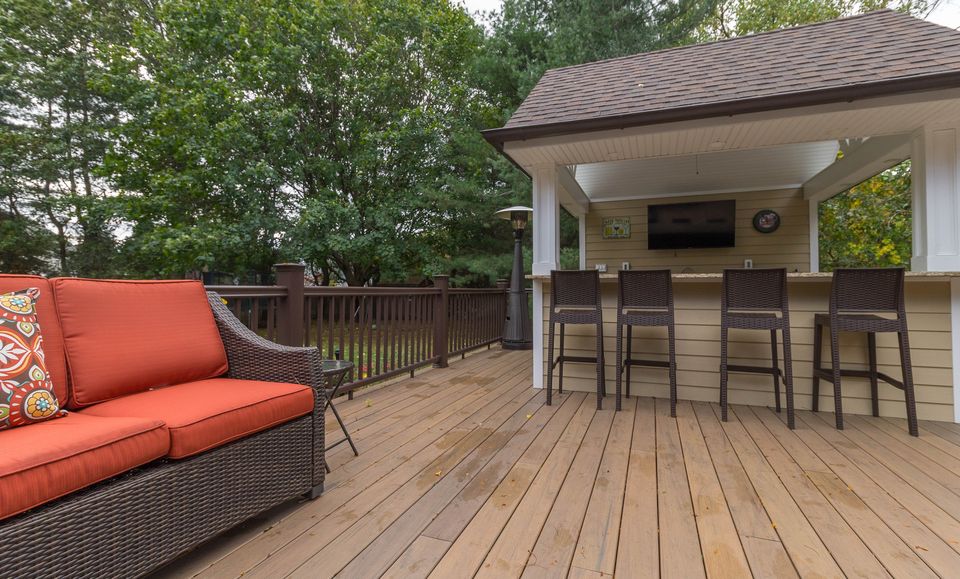 Deck with a cabana bar and seating